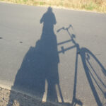 Schatten des Radfahrers auf der Strasse